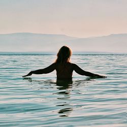 Rear view of woman in sea