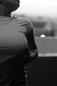 Midsection of woman standing against wall