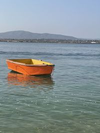 Boat moored in sea against clear sky