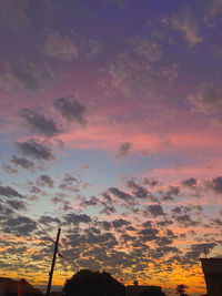 Low angle view of silhouette buildings against sky during sunset