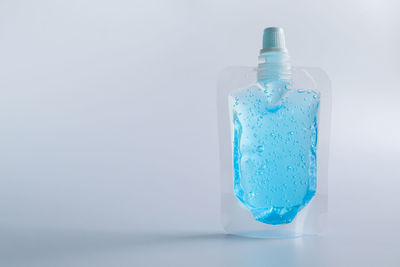 Close-up of blue bottle against white background