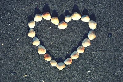 High angle view of heart shape on sand