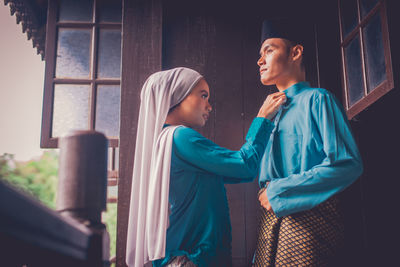 Young couple looking at window