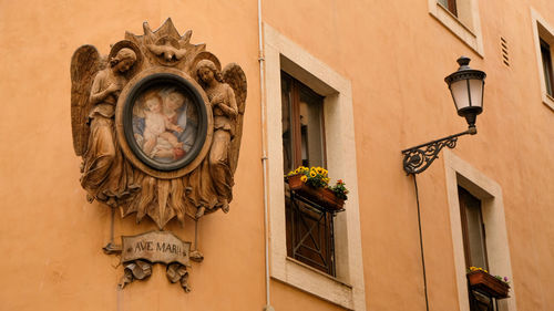 Low angle view of statue against building