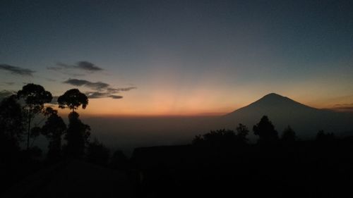 Scenic view of silhouette mountains against sky at sunset