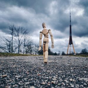 Man standing on road against sky