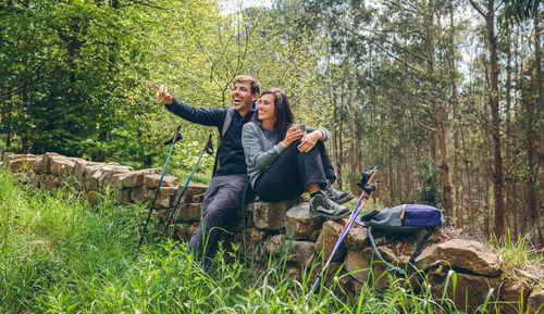 Friends sitting in forest