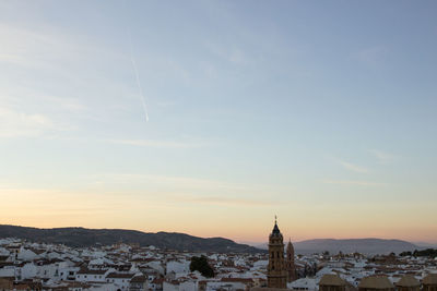 Townscape against sky during sunset