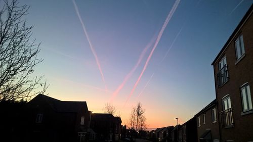 Low angle view of buildings against sky at sunset