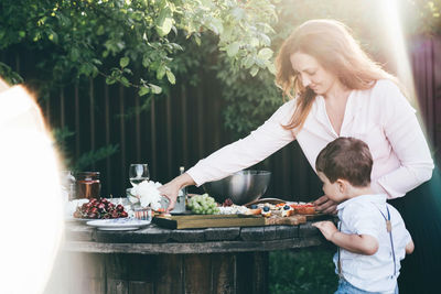 Side view of woman preparing food at home