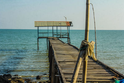 Pier on sea against clear sky