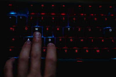 Close-up of hand typing on computer keyboard