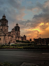 Buildings against sky during sunset in city