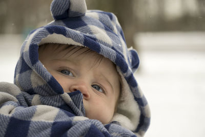 Close-up of baby boy wearing hooded shirt during winter