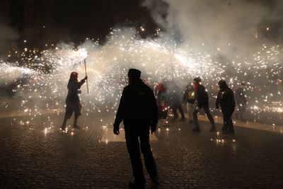 Group of people against sky at night