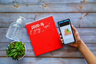 High angle view of man using mobile phone on table