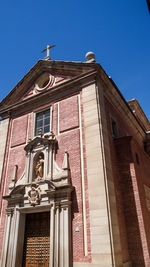 Low angle view of building against clear blue sky