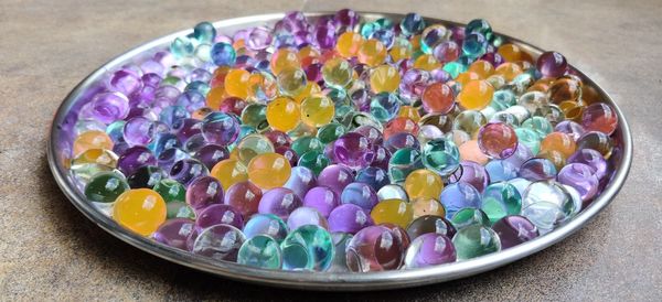 High angle view of multi colored candies in bowl on table