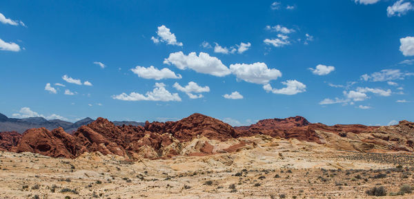 Scenic view of mountains against blue sky