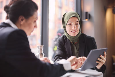 Two businesswomen sitting in cafe