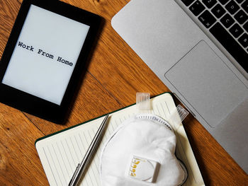 High angle view of laptop and book on table