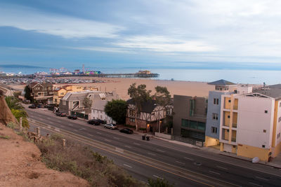 High angle view of road by cityscape against sky