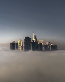 Dubai modern buildings in city against sky with fog