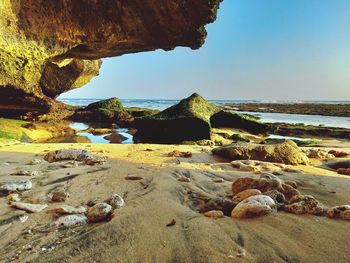 Rocks on beach against sky