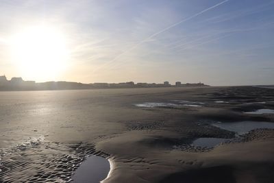 Scenic view of beach against sky during sunset