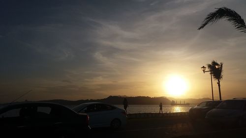 Car parked against sky during sunset