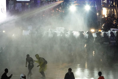 People enjoying at illuminated city at night