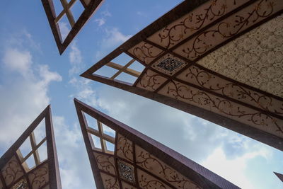 Low angle view of cross against sky