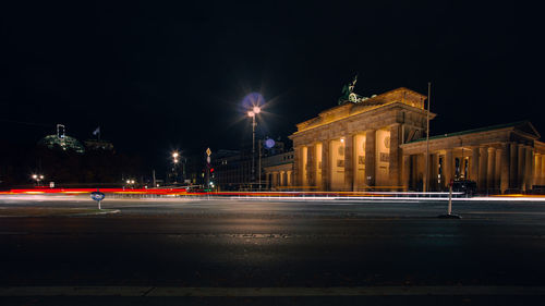 Illuminated building against sky at night