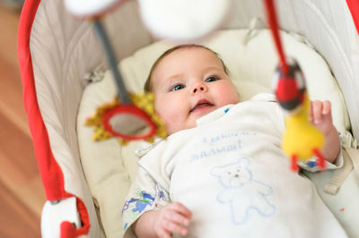 High angle view of cute baby boy sleeping on bed at home