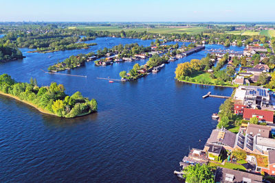 High angle view of townscape by sea against sky