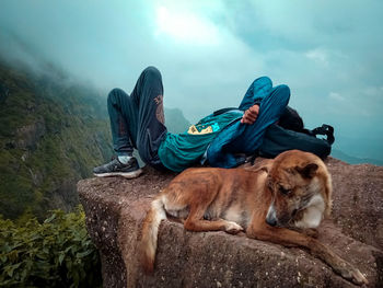 Dog resting against sky