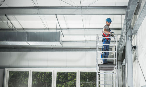 Low angle view of man standing against building