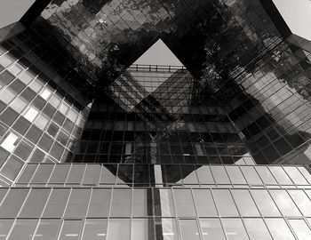 Low angle view of modern glass building in city