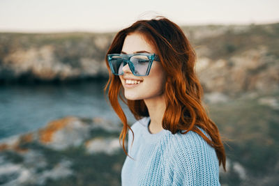 Portrait of young woman wearing sunglasses