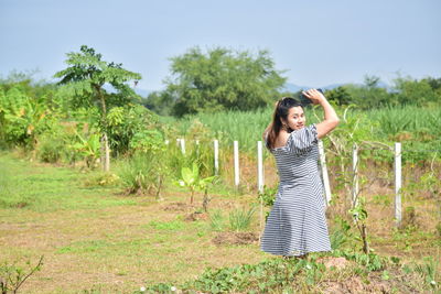 Full length of woman standing on field