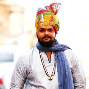 Portrait of man in traditional clothing standing outdoors