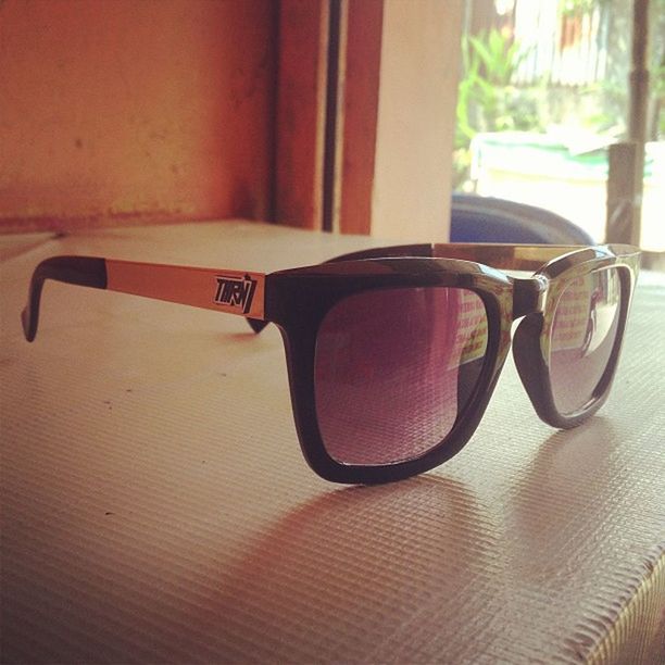 indoors, still life, table, close-up, focus on foreground, no people, single object, absence, chair, communication, empty, day, metal, wood - material, sunlight, sunglasses, red, selective focus, seat, shadow