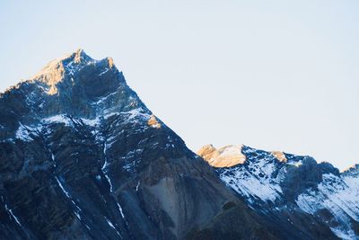 Scenic view of snowcapped mountains against clear sky