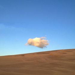 Scenic view of landscape against blue sky