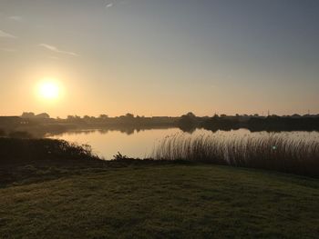 Scenic view of lake against sky during sunset