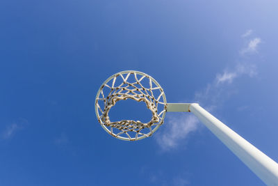 Low angle view of basketball hoop against blue sky