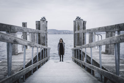 Woman standing on pier