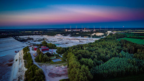 High angle view of mine by landscape against dramatic sky