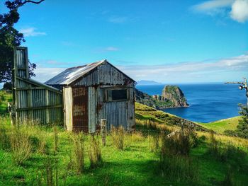 Scenic view of grassy landscape against blue sky