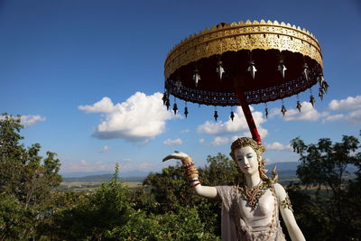 Rear view of woman standing against sky